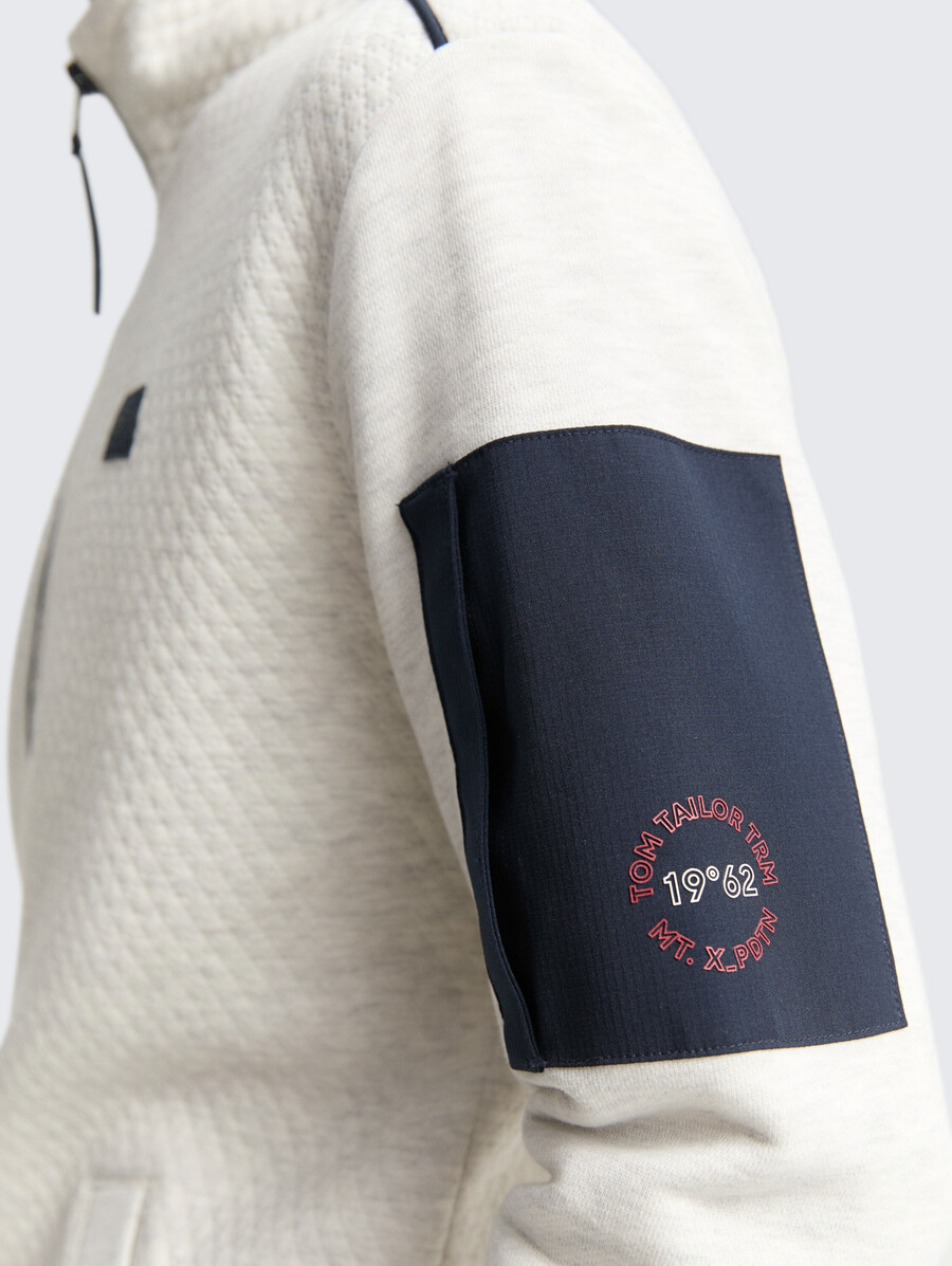 veste de survêtement avec poche sur la manche